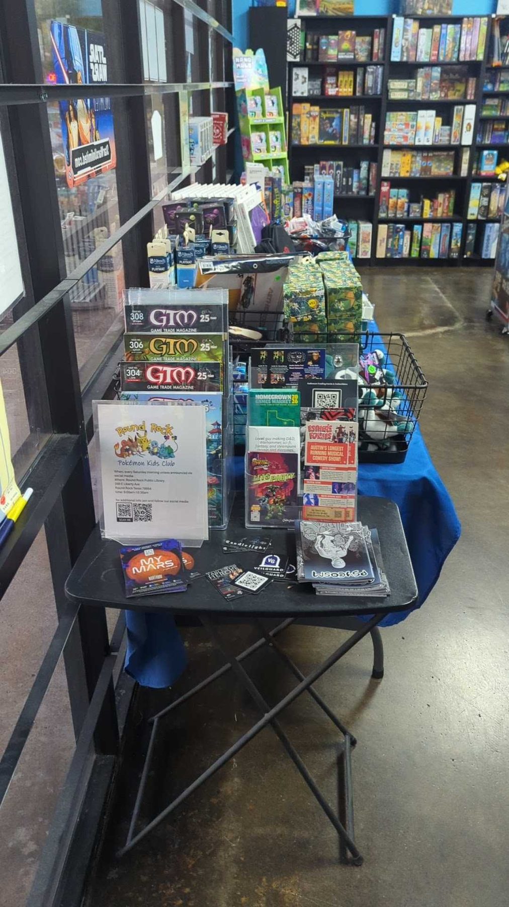 A product display built out in a shop, with a stand, printed shelf cards and a code to scan.