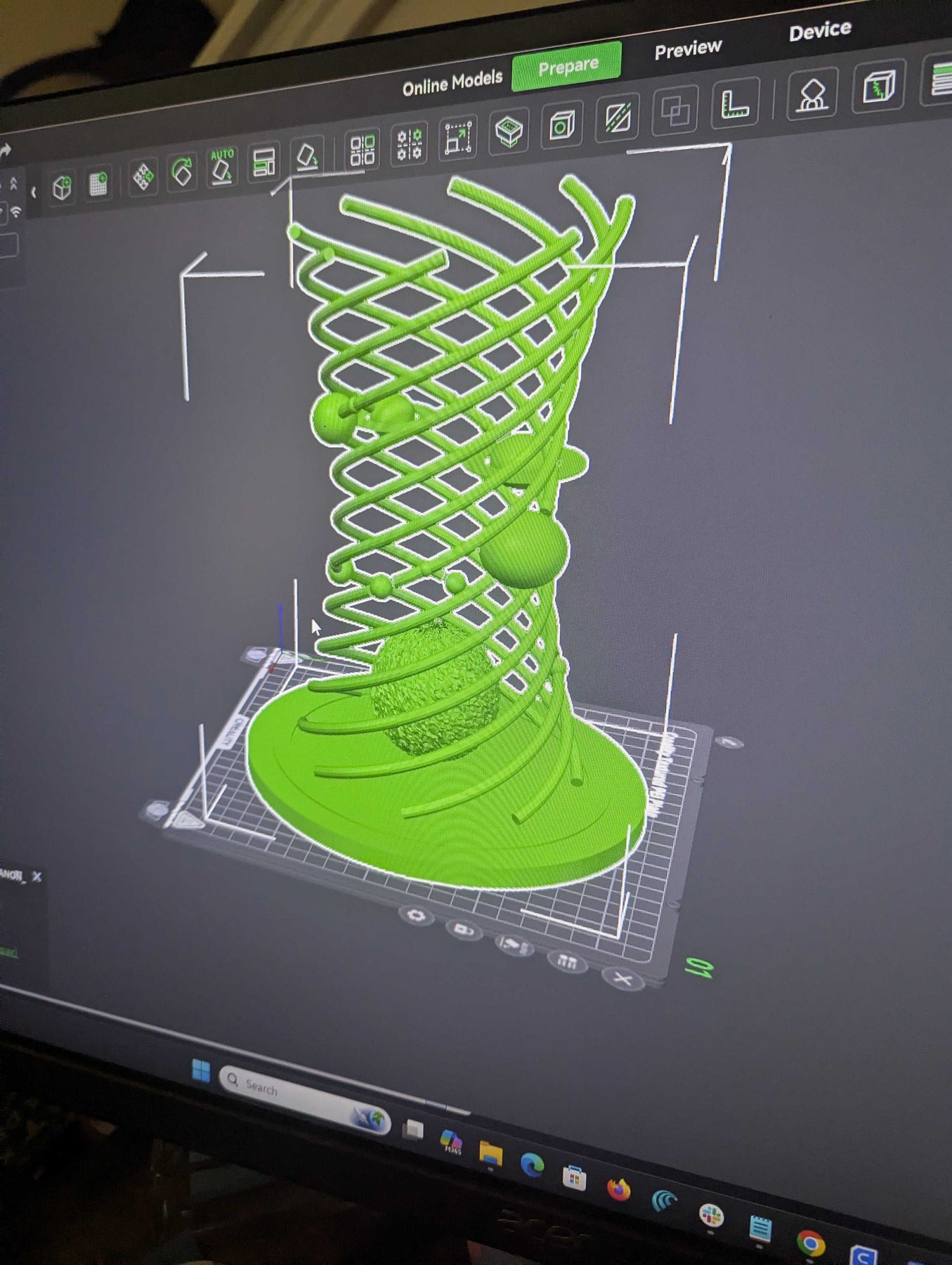 A three-dimensional model of a ridged vase sitting on a virtual build plate in slicing software, before printing.